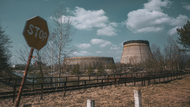 stop sign and power plant in chernobyl