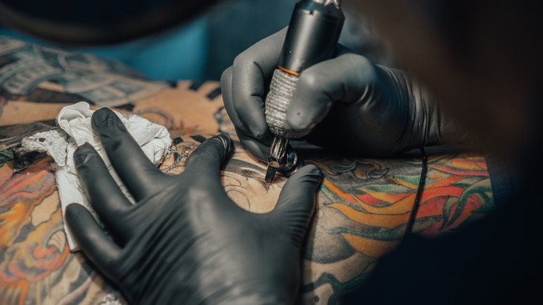 tattoo artist tattooing