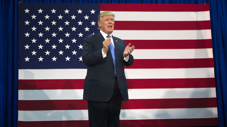 Donald Trump stood in front of US flag