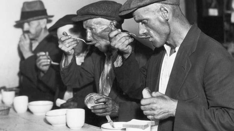 Great Depression men eating at breadline