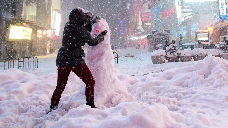 Woman building snowman Times Square 2016