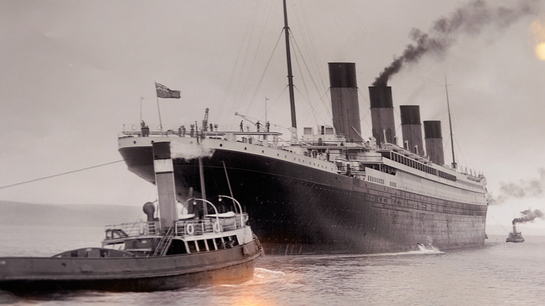 RMS Titanic with smaller ships in front and behind