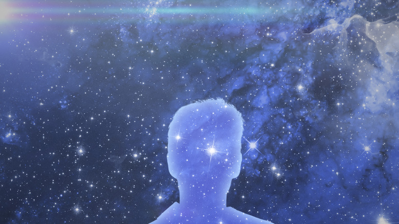 Human silhouette superimposed over cosmos