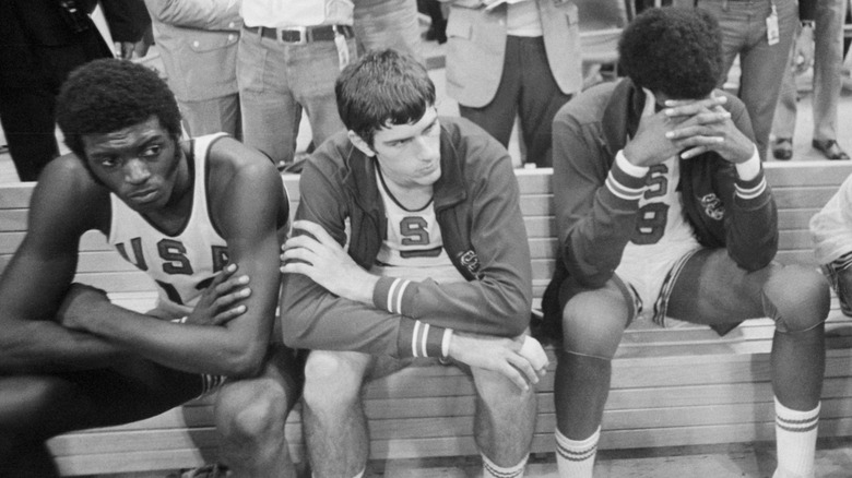 U.S. basketball team members sad on bench at 1972 Olympics