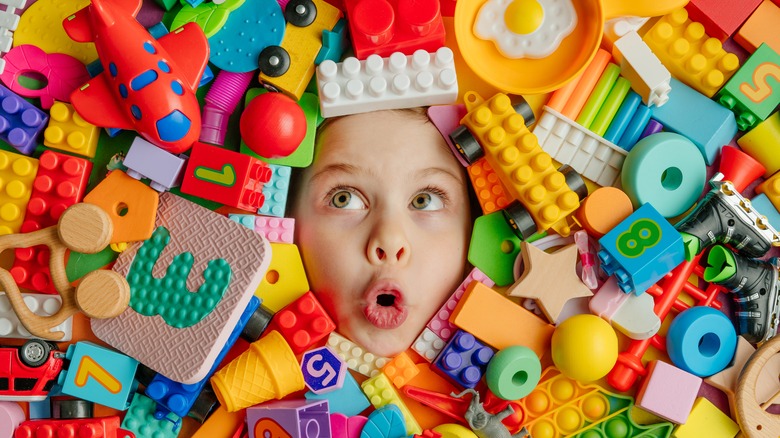 Child surrounded by toys