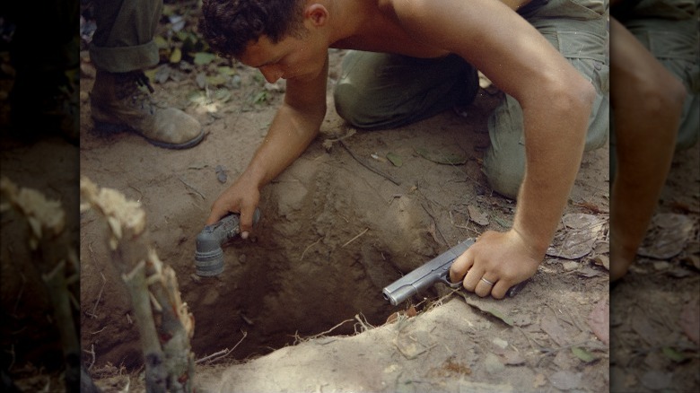 Soldier hunched over tunnel
