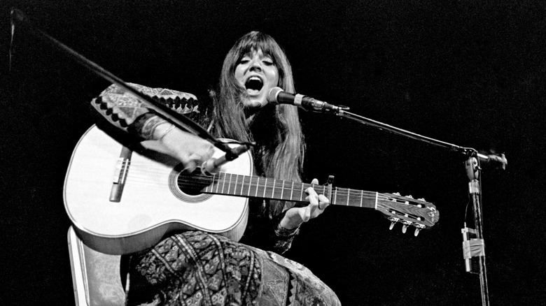 Melanie performing with acoustic guitar