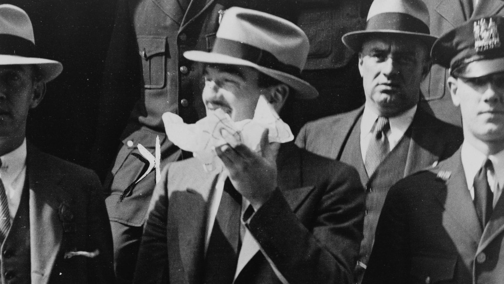 Vincent Coll leaving court surrounded by police officers