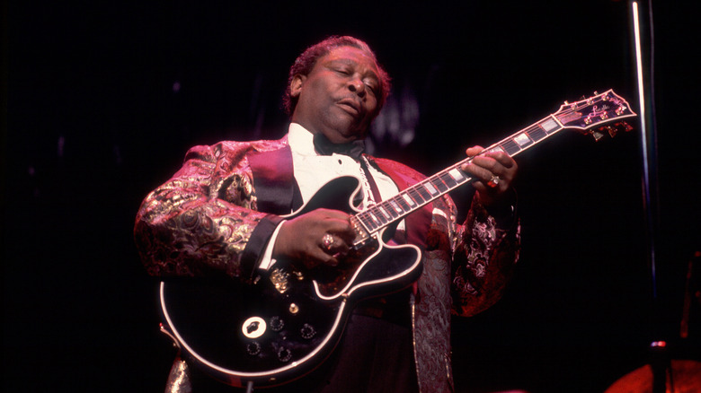 B.B. King emotionally playing his guitar on stage