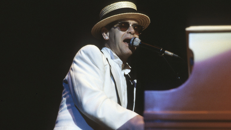 Elton John singing and playing piano