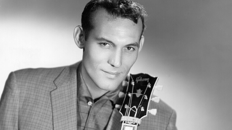 Carl Perkins posing with his guitar