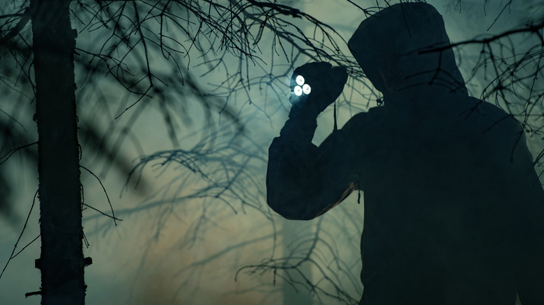 man searching the woods 