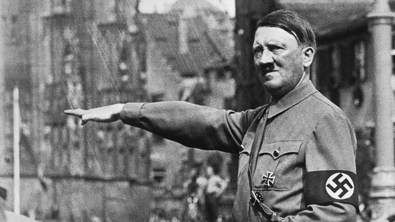 Hitler in uniform giving Nazi salute