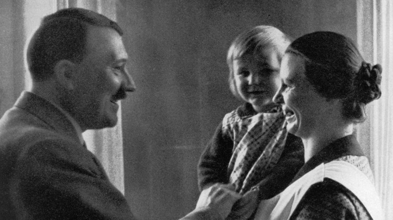 Hitler with a woman and a blonde-haired child