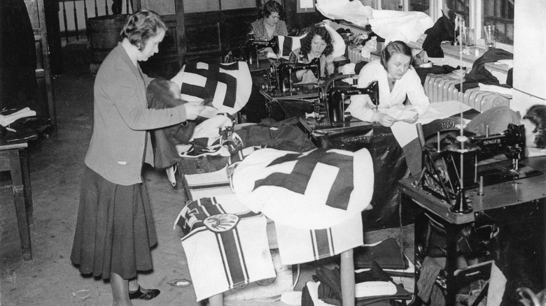 women in a factory making nazi banners