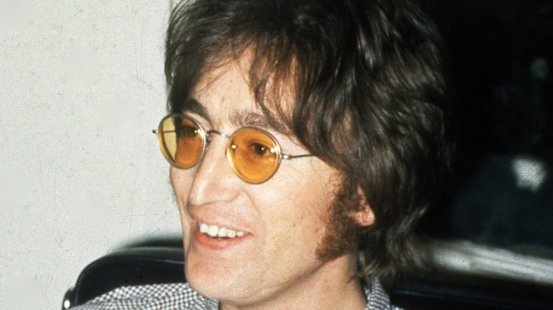 John Lennon smiling wearing sunglasses