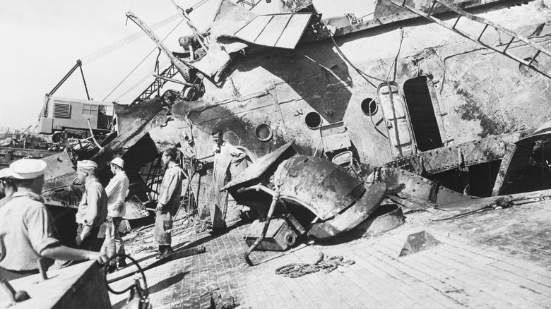 Salvage crew on tilted deck of USS Oklahoma