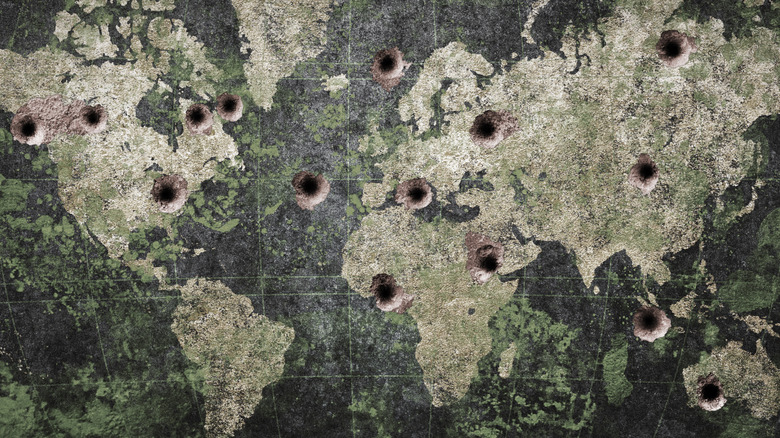 world map with prominent bullet holes