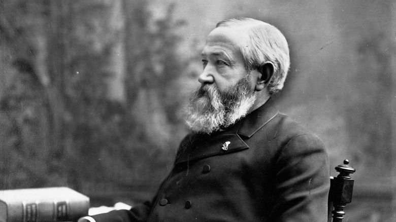 Benjamin Harrison sits with book on table