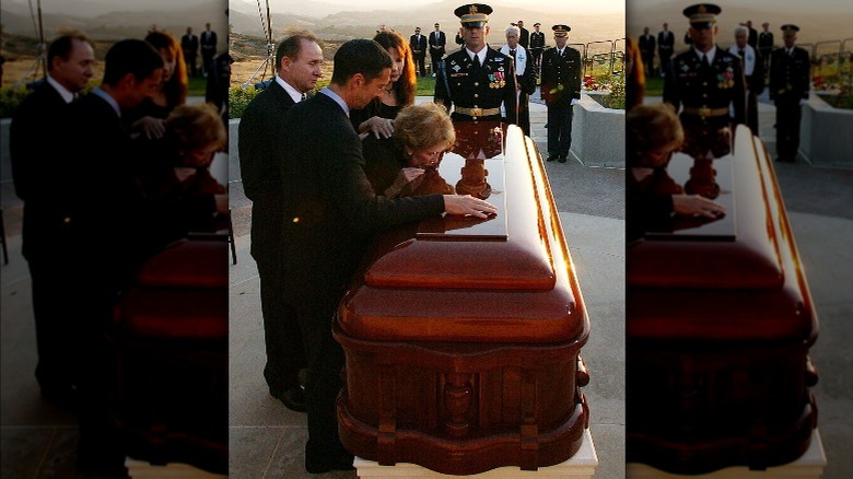 Nancy Reagan kissing Ronald Reagan's coffin