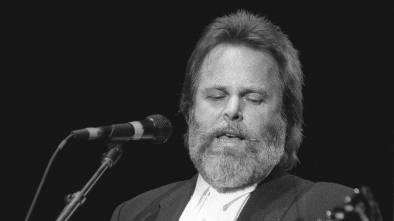 Carl Wilson singing into a microphone