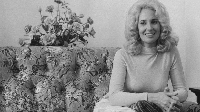Tammy Wynette sitting on a sofa