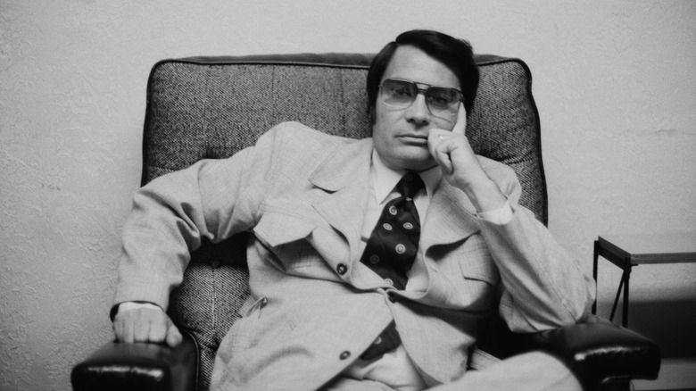 Cult leader Jim Jones seated, 1970s