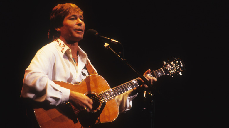 John Denver singing while playing guitar