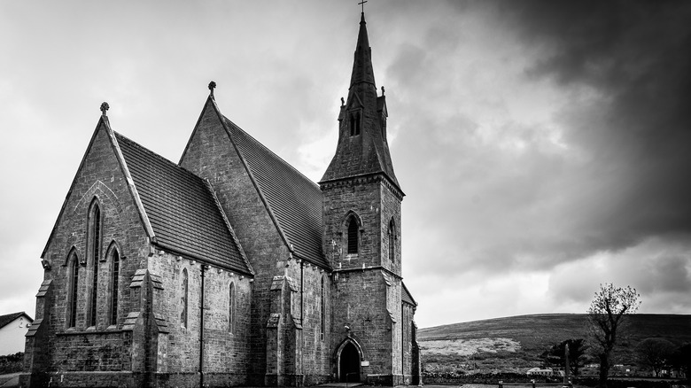 black white photo old church cloudy sky