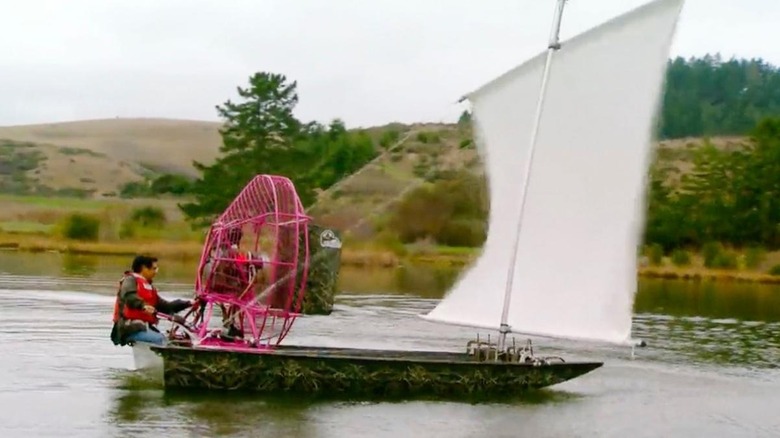 Screenshot of Grant Imahara with large fan blowing into sail