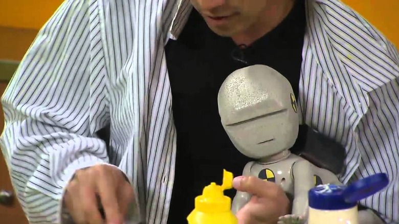 Mythbusters volunteer holding robot baby in closeup