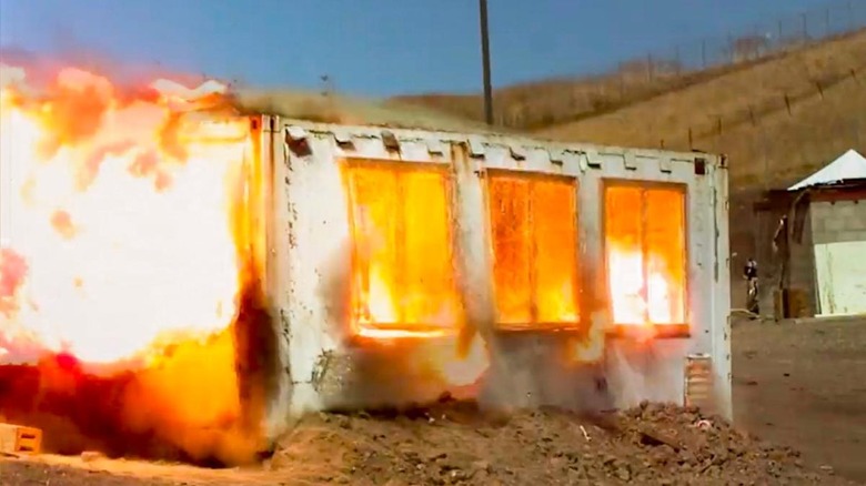 Screenshot of Mythbusters Operation Valkyrie episode, aboveground shipping container mid-explosion