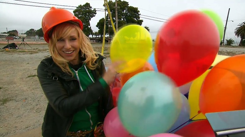 Screenshot of Kari Byron with many colorful balloons