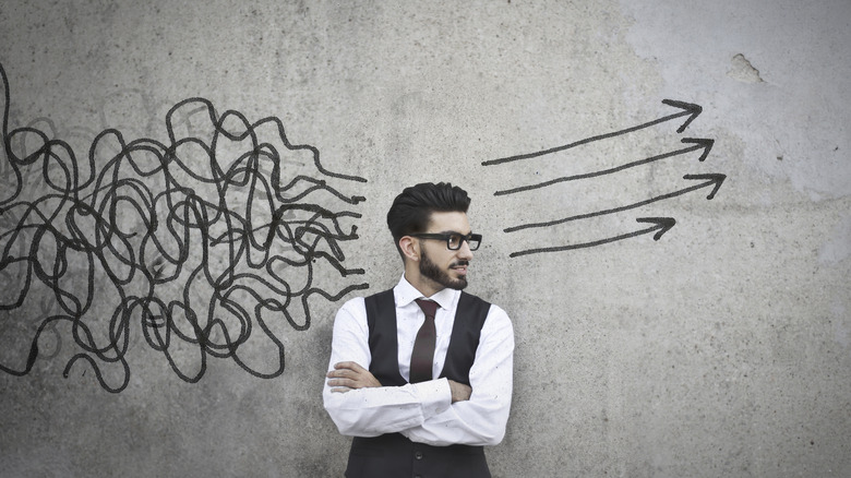 man thinking surrounded with doodles