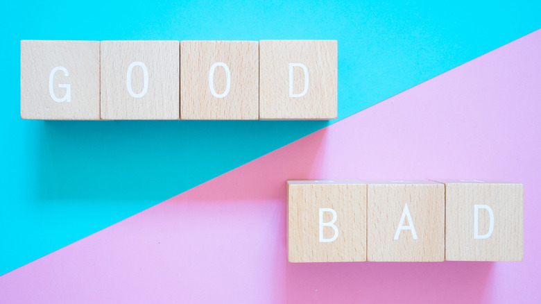 good bad wooden cubes sign