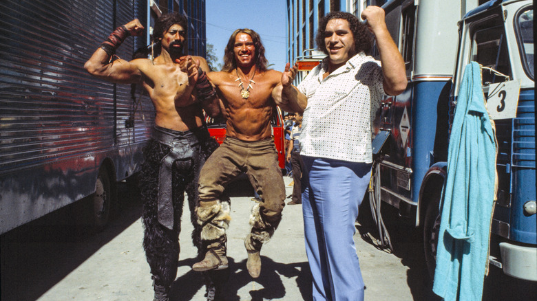 Arnold Schwarzenegger picked up by Wilt Chamberlain and Andre the Giant behind the scenes of Conan the Destroyer