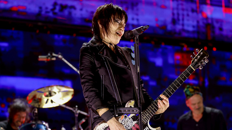 joan jett performing, playing guitar and singing on stage
