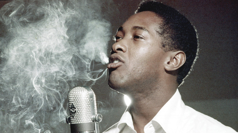 sam cooke with microphone and smoke in background