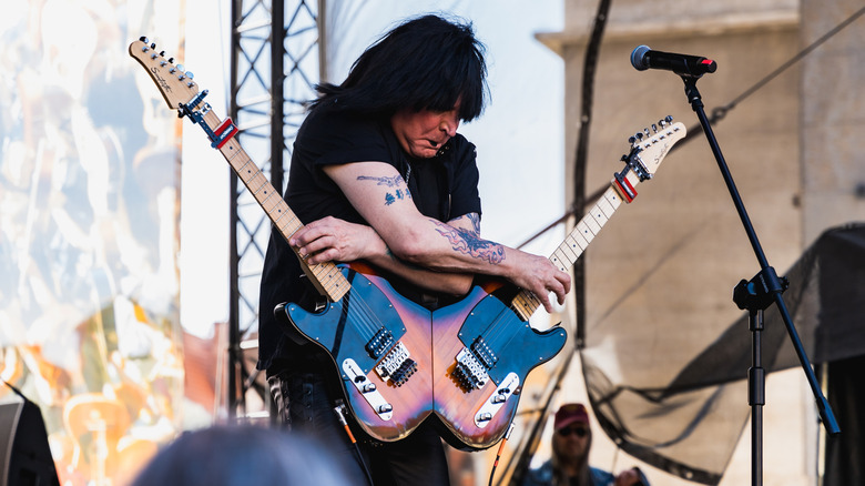 Michael Angelo Batio playing on two guitars in 2023