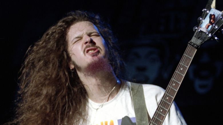 Dimebag Darrell playing guitar and pulling a face in San Jose, Califorina in 1991