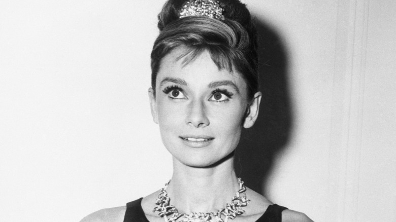 Audrey Hepburn smiling in diamond jewelry