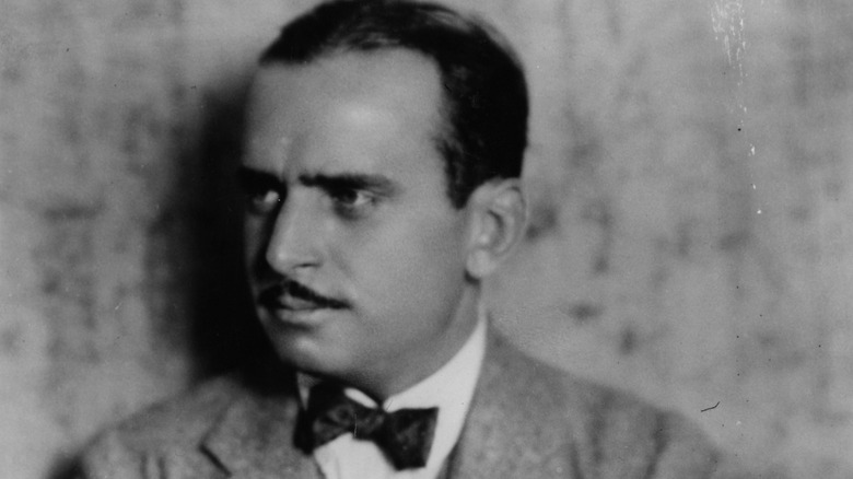 Douglas Fairbanks with moustache and suit looking to his right