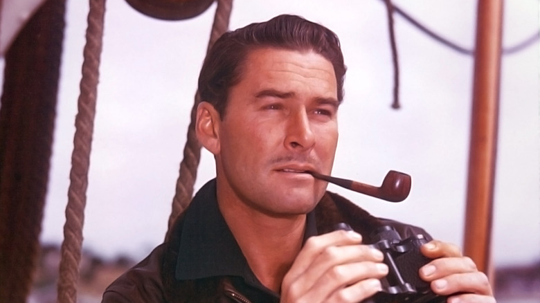 Errol Flynn with pipe holding binoculars
