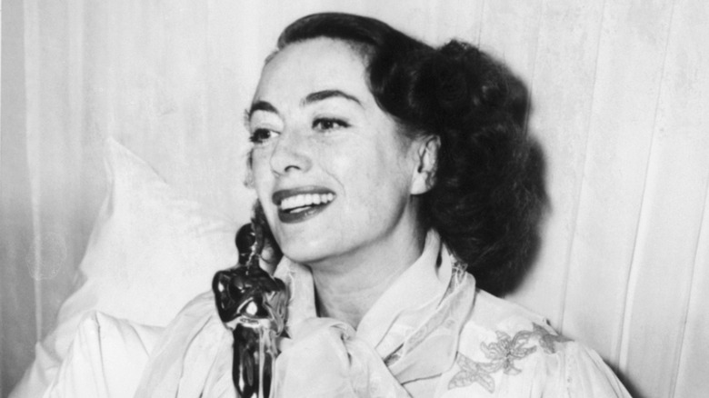 Joan Crawford poses with an Oscar