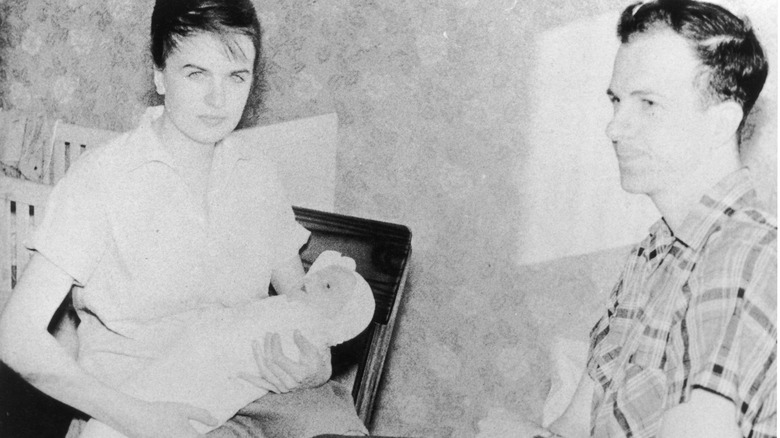 Lee Harvey Oswald sitting with his wife and baby