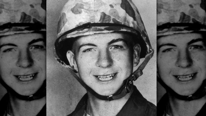 Lee Harvey Oswald in military uniform and helmet
