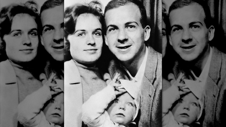 Lee Harvey Oswald, Marina, and their daughter posing for a photo