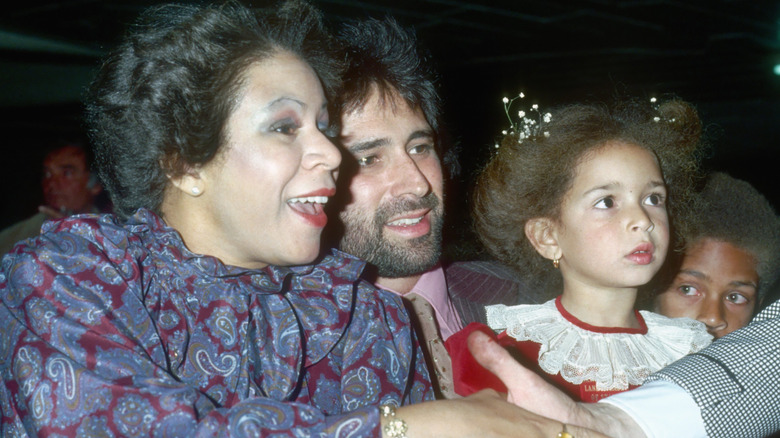 Minnie Riperton shaking hands while Maya Rudolph watches