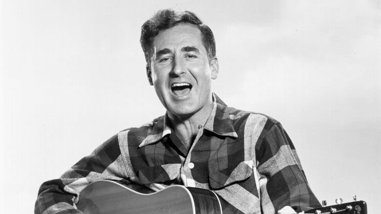 Sheb Wooley singing and playing guitar in plaid shirt