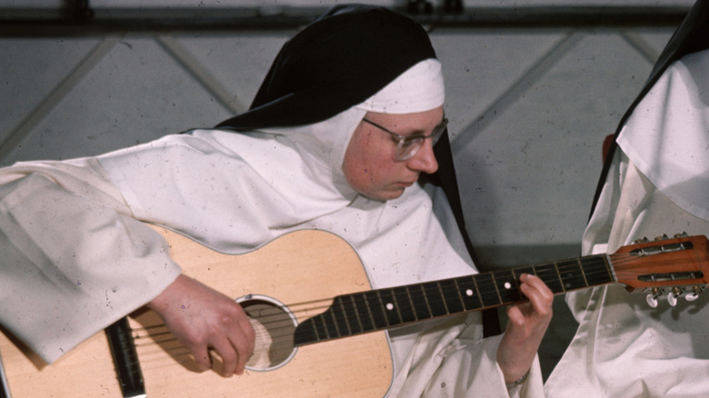 The Singing Nun playing guitar